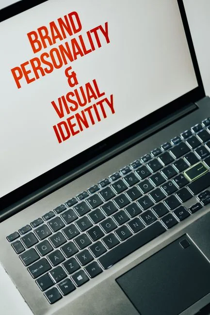 Un espace de travail moderne montrant des mains qui analysent des données marketing sur un ordinateur portable et des documents papier.